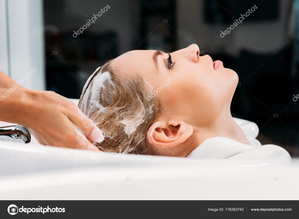 Depositphotos 176363742 stock photo side view hairdresser washing hair